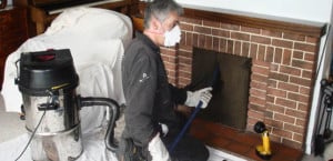 cleaner working on fireplace